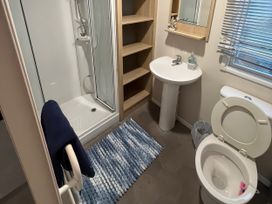 A bathroom with a shower, sink, and toilet at Marton Mere Holiday Village - Holiday Accommodation 18865 Blackpool