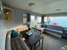a living room with sofas and a table at Seaview Caravan Park - Holiday Accommodation 18903 in Ingoldmells