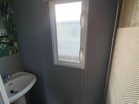 a bathroom with a sink and a window at Seaview Caravan Park - Holiday Accommodation 18903 in Ingoldmells