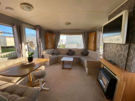a living room with a seating area and a TV at Seaview Caravan Park - Holiday Accommodation 18905 In ingoldmells