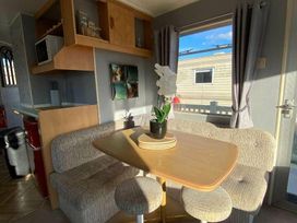 a dining area with a table and seating at Seaview Caravan Park - Holiday Accommodation 18905 in Ingoldmells