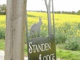 a sign with 'Standen Lodge' and a silhouette of a dog at Standen Lodge - Holiday Accommodation 19045, Mablethorpe
