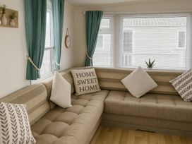 A living room with a sofa and pillows at Whitehouse Leisure Park - Holiday Accommodation 19055 in Towyn, Abergele