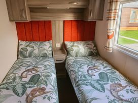 A bedroom with twin beds and a window at Whitehouse Leisure Park - Holiday Accommodation 19057, Towyn, Abergele