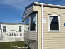A caravan with windows at Southview Holiday Park - Holiday Accommodation 19123, Skegness