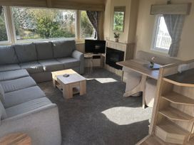 A living room with a sofa and table at Southview Holiday Park - Holiday Accommodation 19123 Skegness