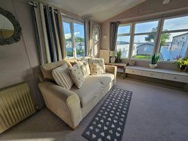 A living room with a sofa and cushions at Littlesea Holiday Park - Holiday Accommodation 19270, Weymouth