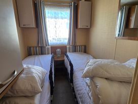 A bedroom with two beds and a window at Littlesea Holiday Park - Holiday Accommodation 19270 in Weymouth