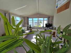 A living room with a view of a sofa and television at Littlesea Holiday Park - Holiday Accommodation 19270, Weymouth