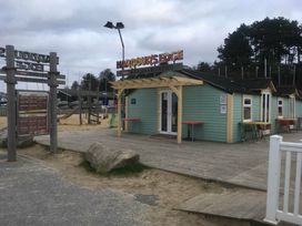 a building with outdoor seating and a sign at Harbour Edge in Poole