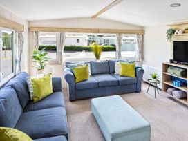 A living room with sofas, a coffee table, and a television at Lido Leisure Park - Holiday Accommodation 19726 Knaresborough