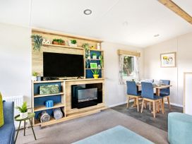 A living room with a television and a dining table at Lido Leisure Park - Holiday Accommodation 19726 in Knaresborough