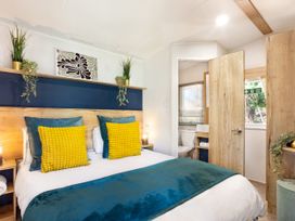 A bedroom with a bed and attached bathroom at Lido Leisure Park - Holiday Accommodation 19726 Knaresborough