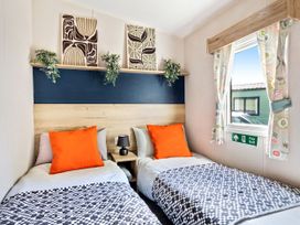 A bedroom with two beds and wall art at Lido Leisure Park - Holiday Accommodation 19726 in Knaresborough