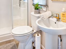 A bathroom with a shower toilet and sink at Lido Leisure Park - Holiday Accommodation 19726 Knaresborough