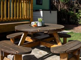 A picnic table with benches and a planter at Lido Leisure Park - Holiday Accommodation 19726 Knaresborough