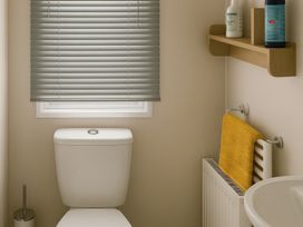 A bathroom with a toilet and sink at Whitley Bay Holiday Park - Holiday Accommodation 19754, Whitley Bay