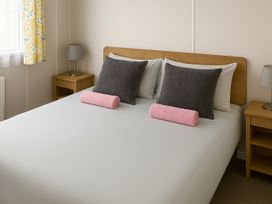 A bedroom with a bed and pillows at Whitley Bay Holiday Park - Holiday Accommodation 19754, Whitley Bay