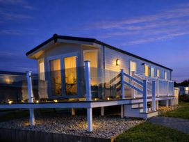 A mobile home with a porch and stairs at Primrose Valley Holiday Park - Holiday Accommodation 20012 in Filey