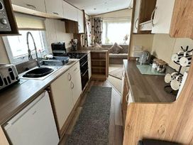 a kitchen with cabinets, a sink, and appliances at Golden Sands Park - Holiday Accommodation 20105 in Ingoldmells, Skegness