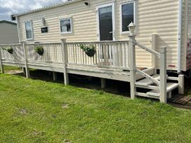 a mobile home with a deck and steps in Golden Sands Park - Holiday Accommodation 20105 in Ingoldmells, Skegness