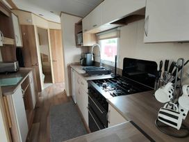 a kitchen with cabinets, stove, and countertop at Golden Sands Park - Holiday Accommodation 20105 in Ingoldmells, Skegness