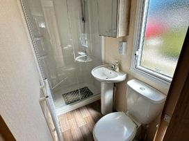 a bathroom with a shower, sink, and toilet at Golden Sands Park - Holiday Accommodation 20105 In Ingoldmells, Skegness