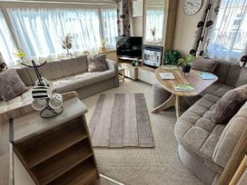 a living room with sofas and a coffee table at Golden Sands Park - Holiday Accommodation 20105 in Ingoldmells, Skegness