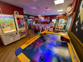 an arcade room with various games including air hockey and claw machines at Golden Sands Park - Holiday Accommodation 20105 in Ingoldmells, Skegness