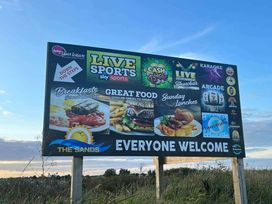 a promotional sign featuring activities and food options at The Sands in Ingoldmells, Skegness