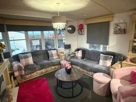 A living room with a sofa and coffee table at Red Lion Holiday Park - Holiday Accommodation 20228 Arbroath