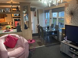 A living room with a sofa and dining table at Red Lion Holiday Park - Holiday Accommodation 20228, Arbroath