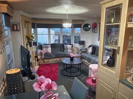 A living room with a sofa and television at Red Lion Holiday Park - Holiday Accommodation 20228 in Arbroath