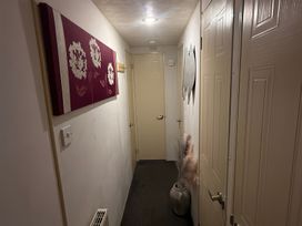 A hallway with artwork and a potted plant at Red Lion Holiday Park - Holiday Accommodation 20228, Arbroath