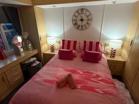 A bedroom with a bed and vanity table at Red Lion Holiday Park - Holiday Accommodation 20228, Arbroath