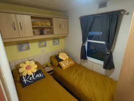 A bedroom with two beds and a window at Red Lion Holiday Park - Holiday Accommodation 20228, Arbroath