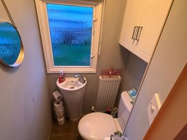 A bathroom with a toilet and sink at Red Lion Holiday Park - Holiday Accommodation 20228 Arbroath