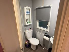 A bathroom with a toilet and sink at Red Lion Holiday Park - Holiday Accommodation 20228, Arbroath