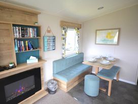 a seating area with a table and decor at Perran Sands - Holiday Accommodation 20230 Perranporth