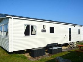 a static caravan with windows and a small deck area at Perran Sands - Holiday Accommodation 20230, Perranporth