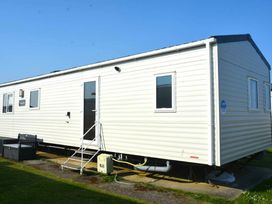 a mobile home with white exterior and multiple windows at Perran Sands - Holiday Accommodation 20230 in Perranporth