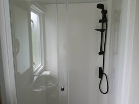 A shower with a black showerhead and hose in a bathroom at Lakeland Leisure Park - Holiday Accommodation 20349 in Grange-Over-Sands