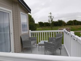 A balcony with two chairs and a table at Lakeland Leisure Park - Holiday Accommodation 20349, Grange-Over-Sands