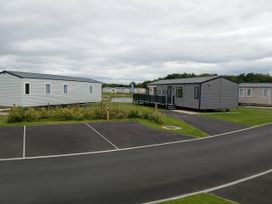 Two static caravans with a parking area at Lakeland Leisure Park - Holiday Accommodation 20349 Grange-Over-Sands