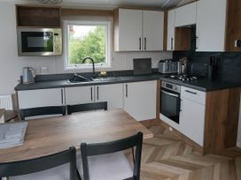A kitchen with a table and chairs at Lakeland Leisure Park - Holiday Accommodation 20349 Grange-Over-Sands