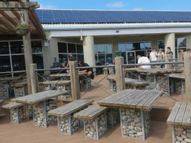 An outdoor seating area with tables and chairs at Lakeland Leisure Park - Holiday Accommodation 20349 Grange-Over-Sands