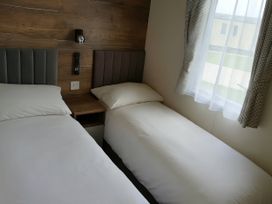A bedroom with two single beds at Lakeland Leisure Park - Holiday Accommodation 20349 Grange-Over-Sands