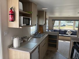 A kitchen with a microwave and kettle at Skipsea Sands Holiday Park - Holiday Accommodation 20390 Driffield
