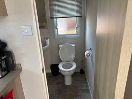 A bathroom with a toilet and sink at Skipsea Sands Holiday Park - Holiday Accommodation 20390 Driffield