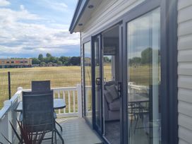 A balcony with a table and chairs at Seashore Holiday Park - Holiday Accommodation 20465 Great Yarmouth